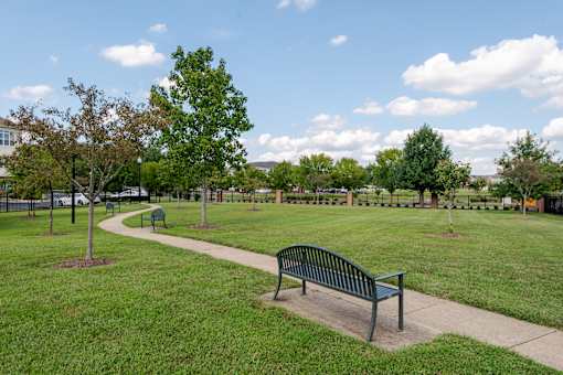 A park with a bench and a path.