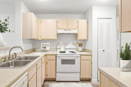 a kitchen with white appliances and wooden cabinets