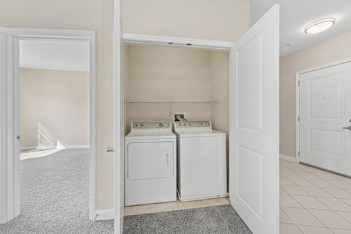 A laundry closet with a washer and dryer.