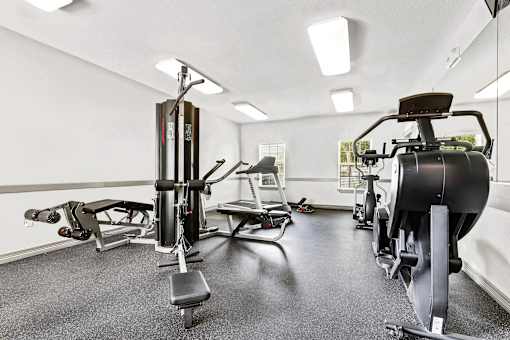 Fitness center with treadmill and weight machines at Tierra Antigua Apartments, Mesa, AZ
