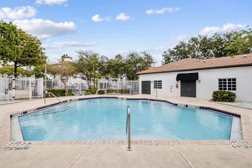our apartments have a large swimming pool and a white building