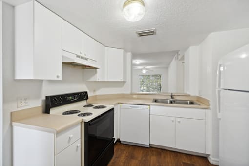the preserve at ballantyne commons apartment kitchen with white cabinets and black appliances