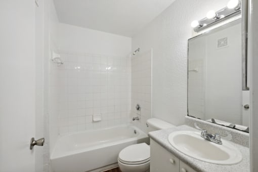 a bathroom with a sink toilet and a bath tub