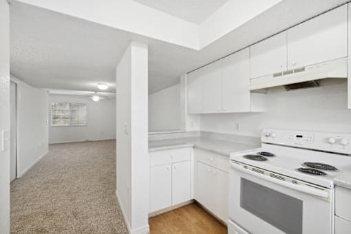a white kitchen with white appliances and white cabinets