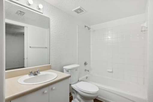 a bathroom with a sink toilet and a bath tub