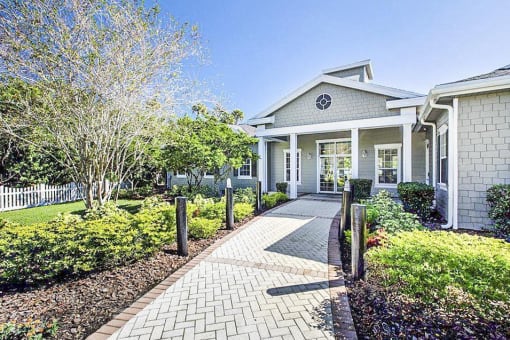 Clubhouse Entrance surrounded by shrubbery and trees