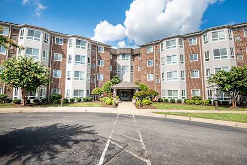 a large apartment building with a street in front of it
