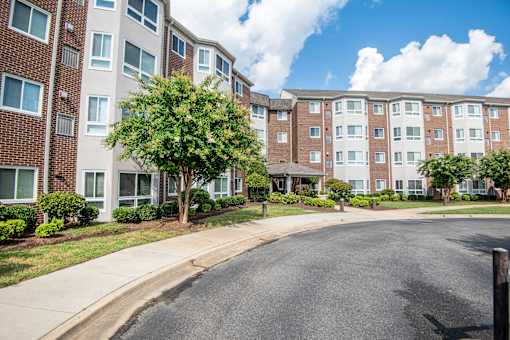 an apartment building with a street in front of it