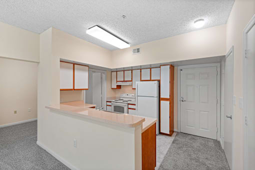 A kitchen area with a refrigerator, microwave, and oven.