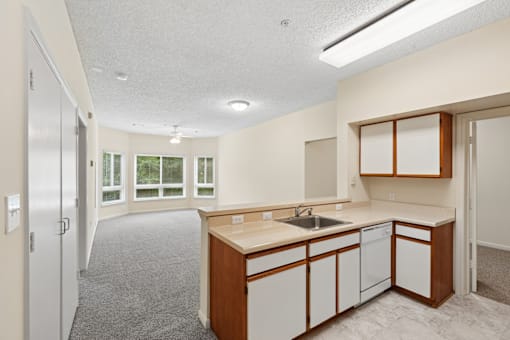 A kitchen with white cabinets and a sink.
