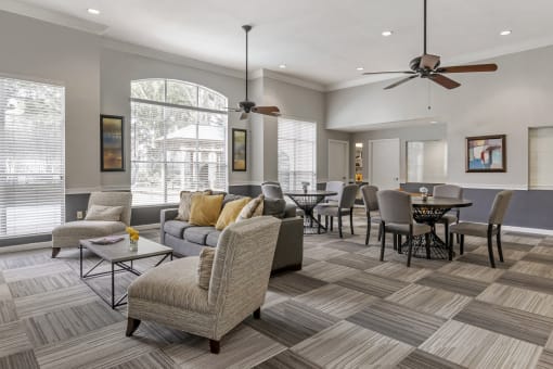 community clubhouse with large windows and multiple seating areas