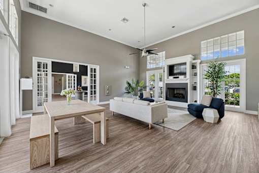 A modern clubhouse with a dining table and a sofa.