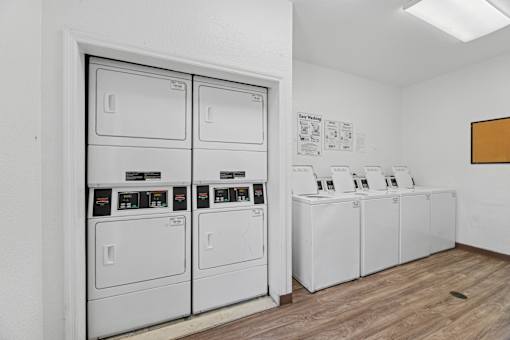A row of washing machines in a laundromat.