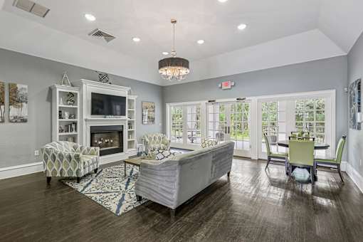 A living room with a fireplace and a dining table.