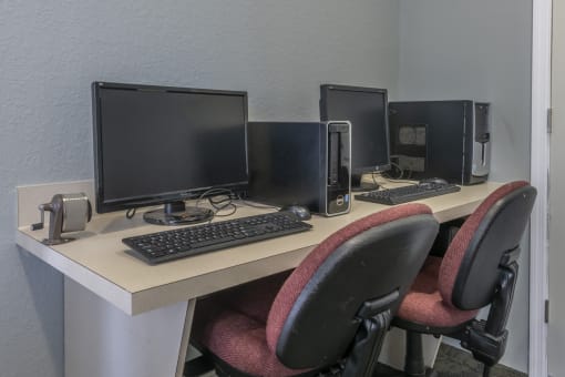 Business Center with three computer monitors and two keyboards