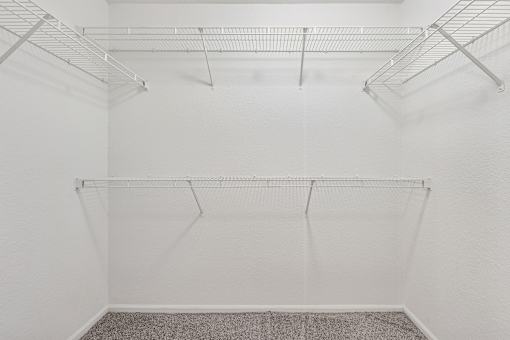 Empty room with white walls and a grey carpet.