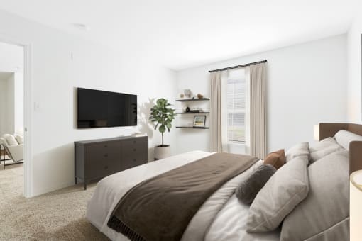 a bedroom with a large bed and a tv on the wall