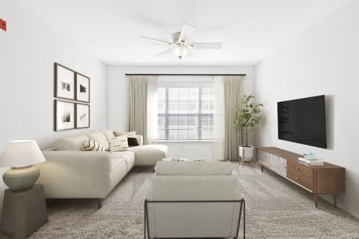 a living room with white walls and a large window