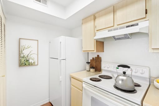 a kitchen with wooden cabinets and white appliances