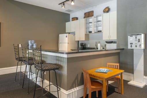 a kitchen with a breakfast bar and a table and chairs