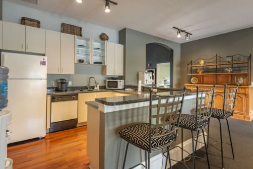 a kitchen with an island and stools