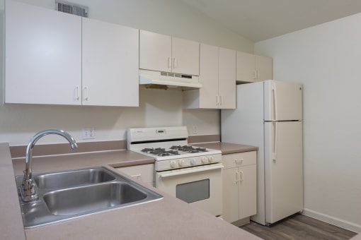 a kitchen with white appliances and white cabinets