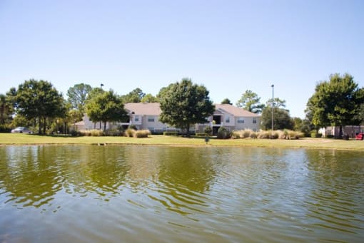 Lake view with exterior buildings