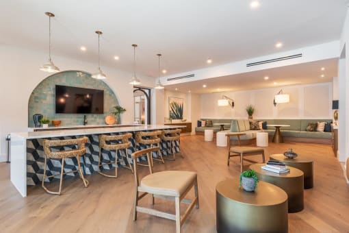 a living room filled with furniture and a bar