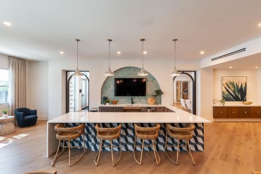 a kitchen with a large island and a tv