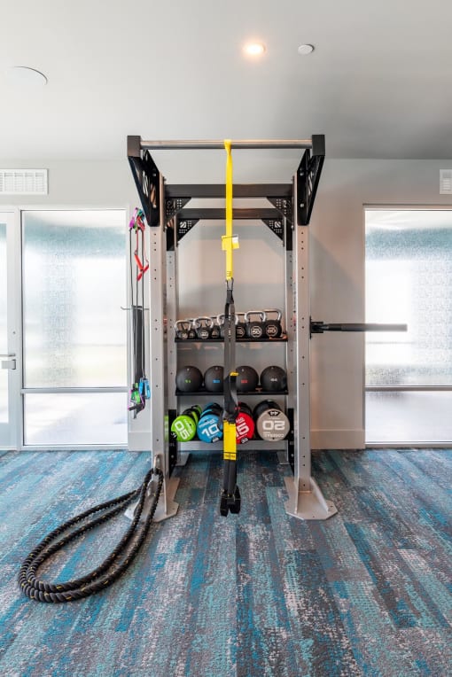 a home gym with a rack and hoses on the floor