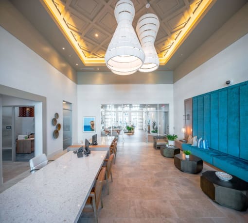 a long dining room with a long table and a blue wall