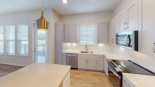a kitchen with white cabinets and stainless steel appliances