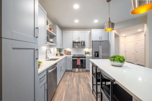 a large kitchen with white cabinets and a white counter top
