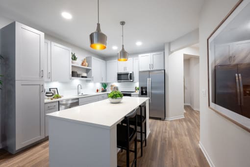 a large kitchen with white cabinets and a white counter top
