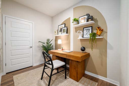 an office with a desk and a chair in a room with a door