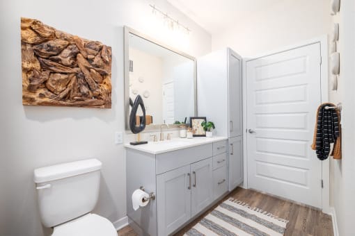 a bathroom with a toilet sink and a mirror