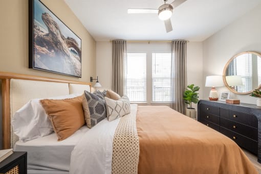 a bedroom with a large bed and a window