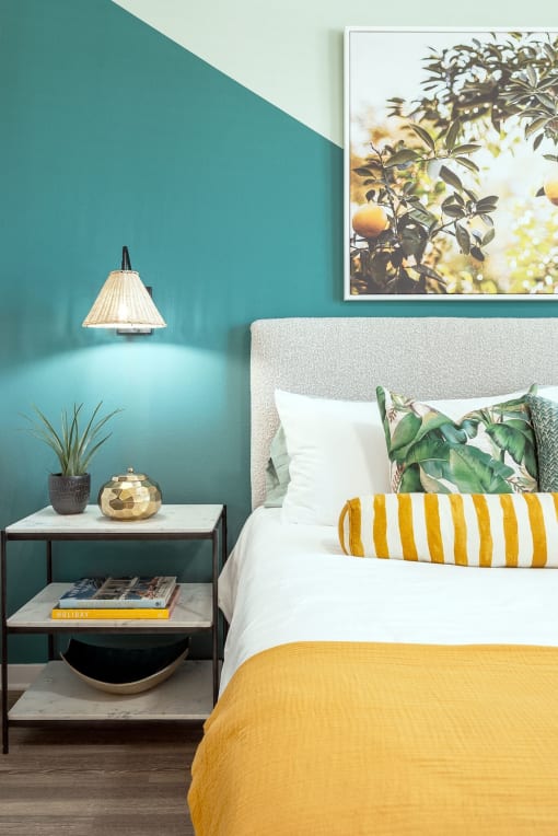 a bedroom with blue walls and a yellow and white bed