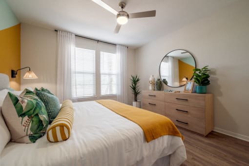 a bedroom with a large bed and a ceiling fan