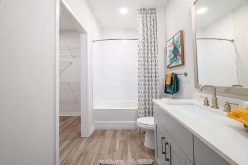 a bathroom with a shower and a sink and a toilet