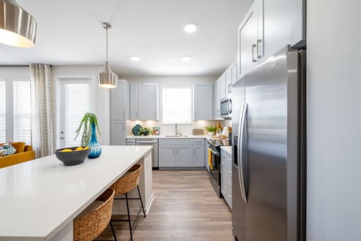a kitchen with stainless steel appliances and a white counter top