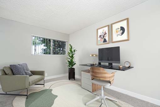 A living room with a couch, chair, and television.