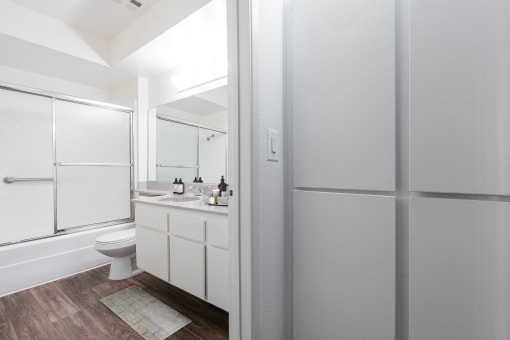 a bathroom with a shower and a toilet and a sink