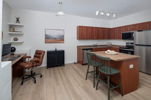 A kitchen with a brown counter and a fridge.