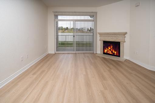 A room with a fireplace and a window with bars.