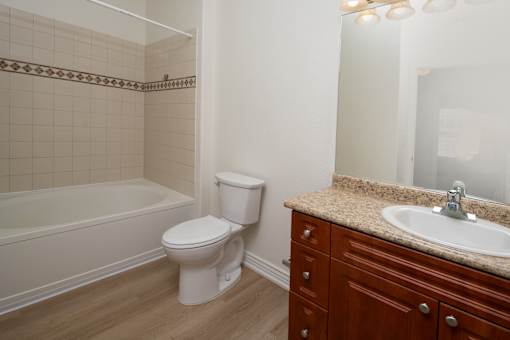 A white toilet sits next to a sink in a bathroom.