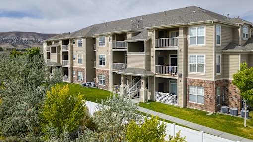 A large apartment complex with a mountain in the background.