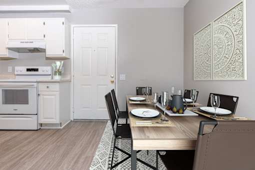 A dining room with a table set for two.