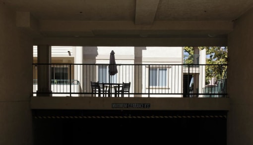 a balcony with a table and chairs in a building