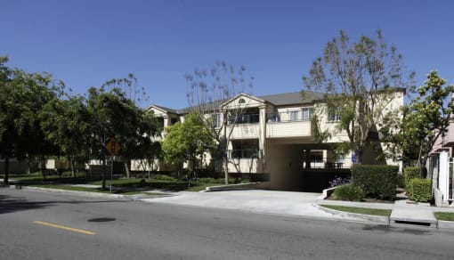 an empty street in front of an apartment building
